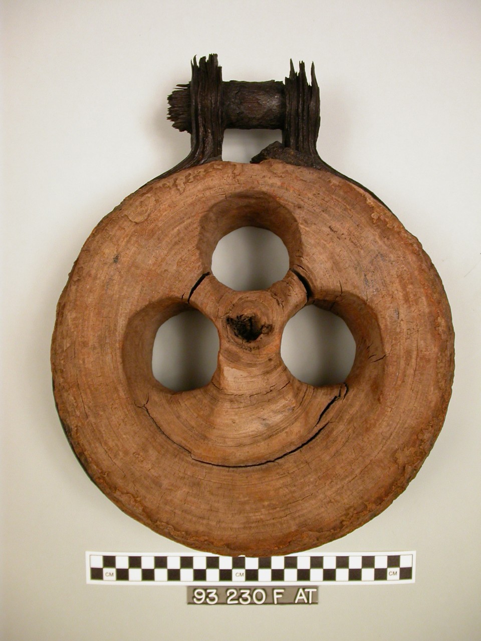 A deadeye is thick, wooden circular disc with three holes in the center one on top and two on bottom.  Encircling the wood is a piece of iron that tapers outward toward the top with an iron bolt going through it.  The iron would have attached to the ship and rope would be pulled through the holes. 