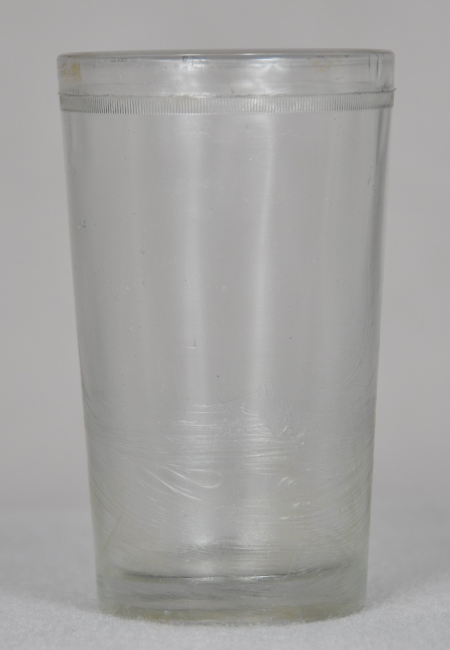 <p>A clear drinking glass with a ribbed border close to the rim of the cup.</p>