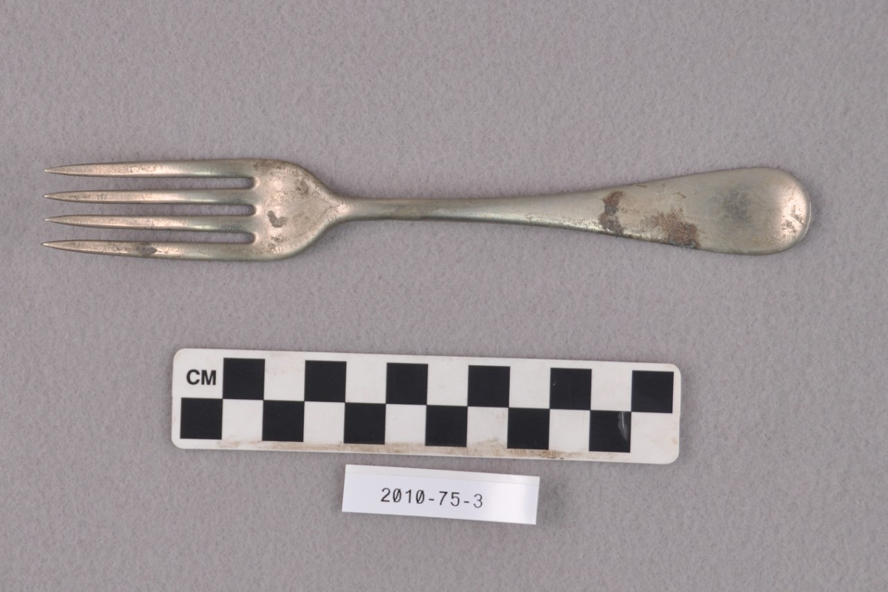 <p>An undecorated silver plated four prong fork with letters “Wm. A. Rogers / S.N. / R” stamped on the handle from USS San Diego.</p>
