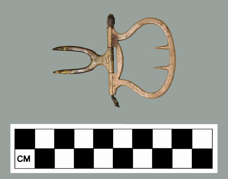 Figure 3 A mid-eighteenth century brass shoe buckle discovered at the wreck site in 1999. It was likely worn by one of the vessel's junior officers.